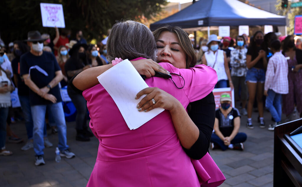 Esther Lemus, right, embraces Pat Sabo, chairman of the Sonoma County Democratic Party, after Lemus gave a speech to around 500 people, Saturday Oct. 2, 2021 at Old Courthouse Square as part of a Rally for Women's Rights and Voting Rights, held in coordination with the Women's March in Washington D.C. Lemus spoke of her support for abortion rights and the support she has felt since she accused ex-Windsor mayor Dominic Foppoli of sexual assault. (Kent Porter / The Press Democrat) 2021