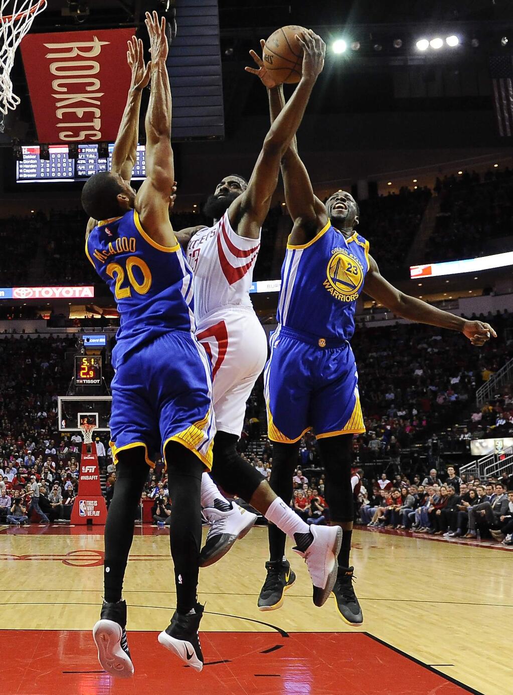 Golden State Warriors forward Draymond Green (23) blocks the shot of Houston Rockets guard James Harden, center, as forward James Michael McAdoo defends during the first half Friday, Jan. 20, 2017, in Houston. (AP Photo/Eric Christian Smith)