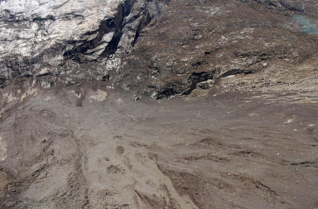 In this Tuesday, April 28, 2015 photo provided by Medecins Sans Frontieres, a lone house, center, is visible after a quake-triggered mudslide wiped out the village of Langtang, about 60 kilometers (35 miles) north of Kathmandu, Nepal. Rescuers were digging Tuesday, May 5 through thousands of tons of earth from a mudslide triggered by the April 25 massive earthquake in Nepal that wiped out the entire village along a popular Himalayan trekking route. The village is now about a two-day hike from the nearest town because the landslide has blocked roads in the area. (Medecins Sans Frontieres via AP) NO ARCHIVING, NO LICENSING
