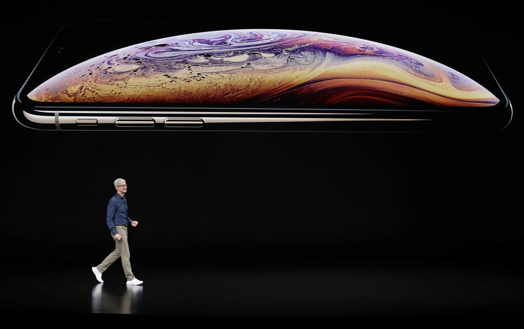 Apple CEO Tim Cook speaks about the Apple iPhone XS at the Steve Jobs Theater during an event to announce new Apple products Wednesday, Sept. 12, 2018, in Cupertino, Calif. (AP Photo/Marcio Jose Sanchez)