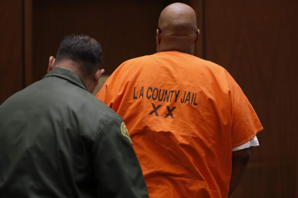 Former rap mogul Marion 'Suge' Knight is escorted out of the Los Angeles Superior Court Thursday, Sept. 20, 2018. Averting a murder trial that had been nearly four years in coming, Knight pleaded no contest Thursday to voluntary manslaughter for running over and killing a Compton businessman and agreed to serve nearly 30 years in prison. The Death Row Records co-founder entered the plea in court after striking a deal with prosecutors, and has agreed to serve 28 years. Jury selection for his trial, which could have led to a life sentence, had been scheduled to begin Monday. (Gary Coronado/Los Angeles Times via AP, Pool)