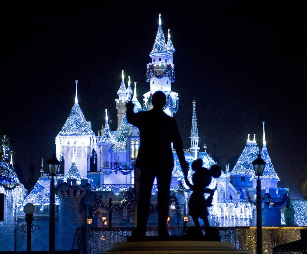 FILE - This Nov. 20, 2009 photo shows Sleeping Beauty's Castle in winter dress with the iconic 'Partners' statue featuring images of Walt Disney and Mickey Mouse in the foreground, at Disneyland in Anaheim, Calif. Measles cases have been popping up around California in an outbreak linked to visits to Disneyland and Disney's California Adventure theme parks during the winter 2014 holiday. (AP Photo/The Orange County Register, H. Lorren Au Jr., FILE)