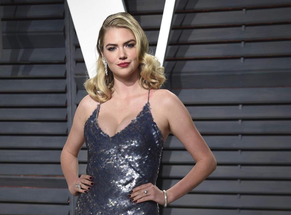 FILE- In this Feb. 26, 2017, file photo, Kate Upton arrives at the Vanity Fair Oscar Party in Beverly Hills, Calif. Shares of Guess are falling after Upton posted about company's co-founder Paul Marciano on social media on Wednesday, Feb. 1, 2018. Guess couldn't be immediately reached for comment. (Photo by Evan Agostini/Invision/AP, File)