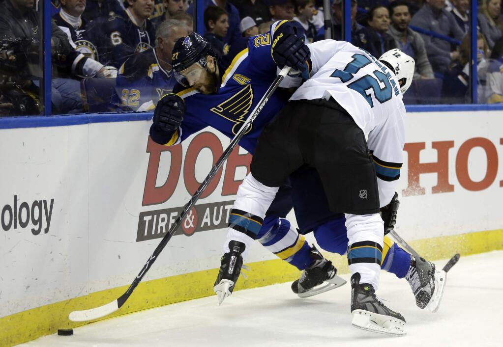 St. Louis Blues defenseman Alex Pietrangelo (27) chases the puck against San Jose Sharks center Patrick Marleau (12) during the first period in Game 1 of the NHL hockey Stanley Cup Western Conference finals, Sunday, May 15, 2016, in St. Louis. (AP Photo/Jeff Roberson)