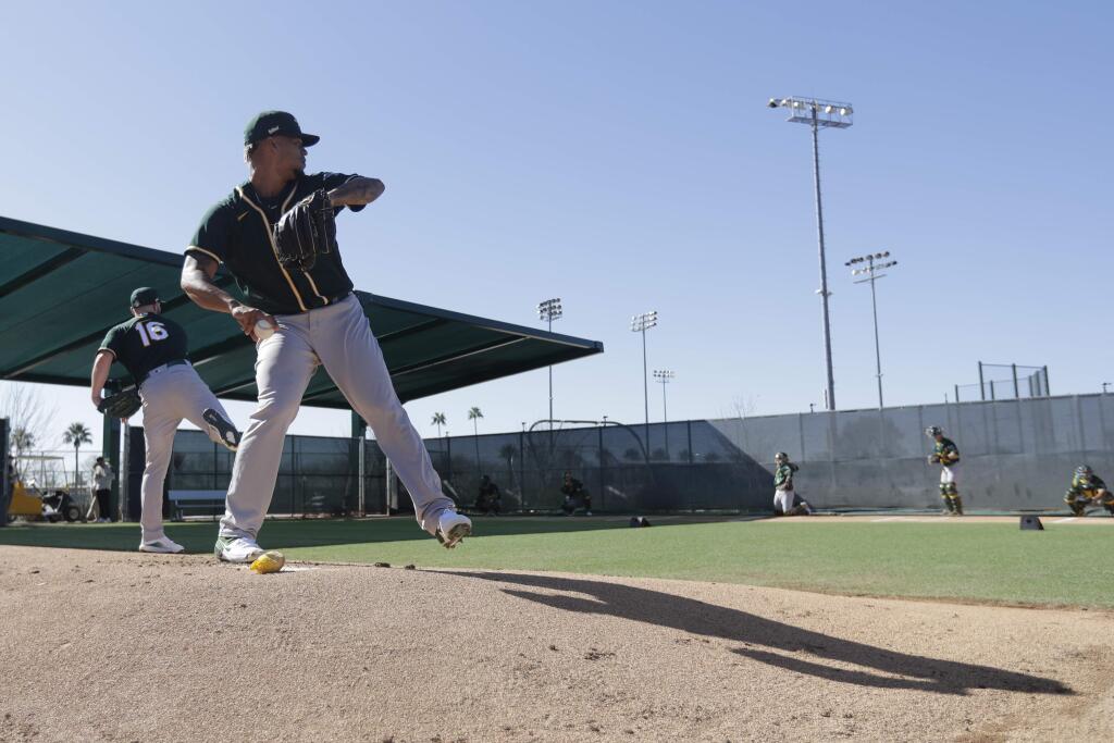 The Oakland Athletics' Frankie Montas throws during spring training, Thursday, Feb. 13, 2020, in Mesa, Ariz. (AP Photo/Darron Cummings)