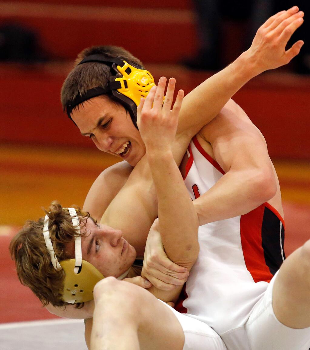Montgomery's Austin Whitley, right, tries to subdue Windsor's Elliot Robinson during their 126 lbs. match in the varsity wrestling meet between Windsor and Montgomery high schools in Santa Rosa, California on Tuesday, January 10, 2017. (Alvin Jornada / The Press Democrat)