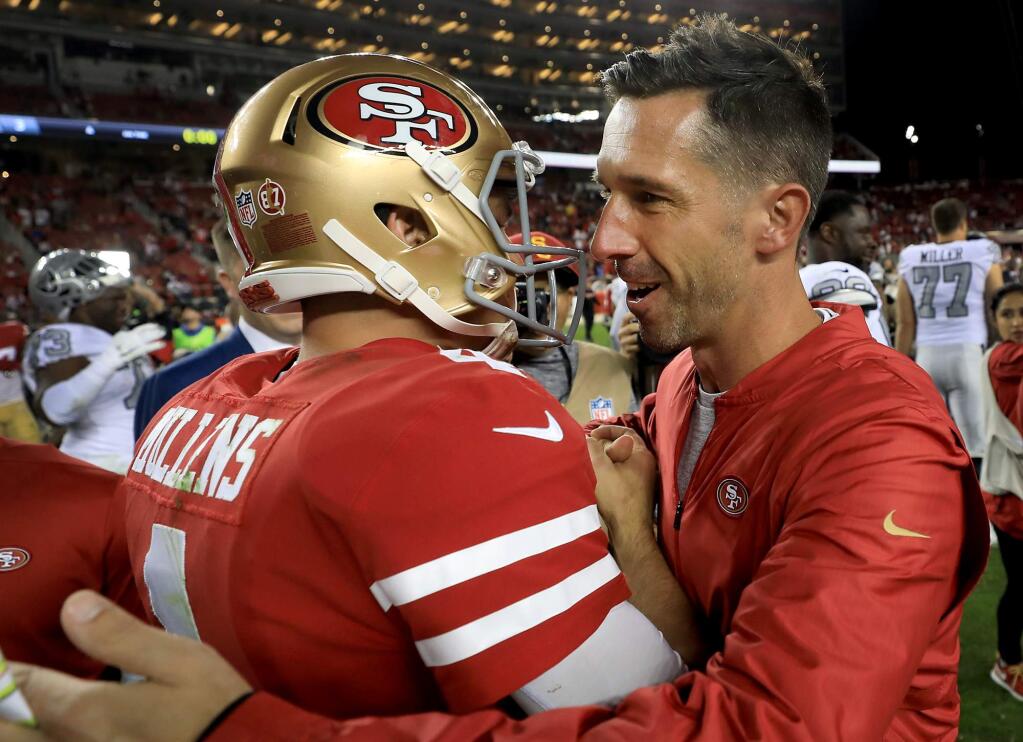 Rookie quarterback Nick Mullens is congratulated by San Francisco head coach Kyle Shanahan after the 49ers' 34-3 victory against the Oakland Raiders on Thursday, Nov. 1, in Santa Clara. (Kent Porter / The Press Democrat)