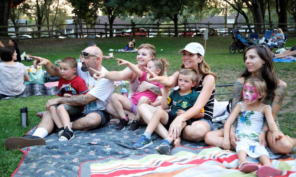 Parents and their kids wait for the movie to start, (l to r) Bren, David, Heather and Leanna Mones, Stacey and Fin Molencup, Frankie Lou and Jessica Dehaven-Mehew. The City of Santa Rosa Parks and Recreation Department hosts Movies in the Park each week during the summer at Howarth Park in Santa Rosa. This week's movie was 'Moana,' on Friday, Sept. 1, 2017. See schedule at srcity.org/2170/Movies-in-the-Park. (Will Bucquoy / Press Democrat)