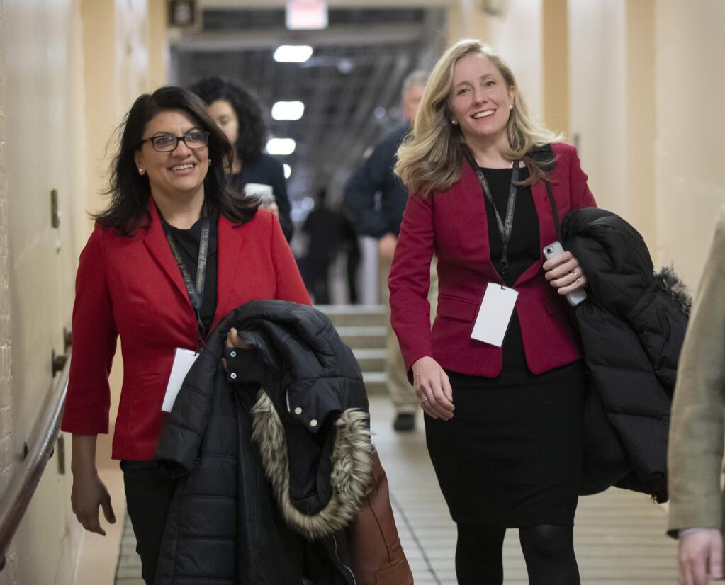 Rep.-elect Rashida Tlaib, D-Mich., left, and Rep.-elect Abigail Spanberger, D-Va., head to a Democratic Caucus meeting in the basement of the Capitol as new members of the House and veteran representatives gathered behind closed doors to discuss their agenda when they become the majority in the 116th Congress, in Washington, Thursday, Nov. 15, 2018. Spanberger defeated Rep. Dave Brat, R-Va., a member of the conservative House Freedom Caucus. (AP Photo/J. Scott Applewhite)