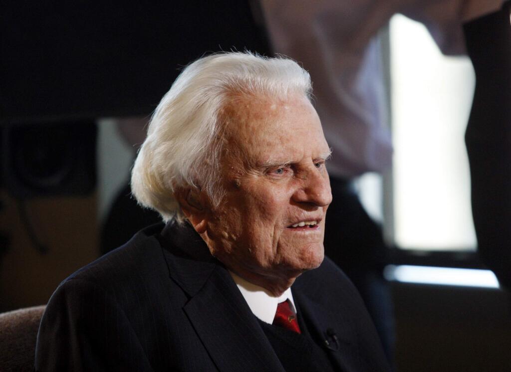 FILE - In this Dec. 20, 2010 file photo, evangelist Billy Graham, 92, speaks during an interview at the Billy Graham Evangelistic Association headquarters in Charlotte, N.C. Graham, who transformed American religious life through his preaching and activism, becoming a counselor to presidents and the most widely heard Christian evangelist in history, has died. Spokesman Mark DeMoss says Graham, who long suffered from cancer, pneumonia and other ailments, died at his home in North Carolina on Wednesday, Feb. 21, 2018. He was 99. (AP Photo/Nell Redmond, File)