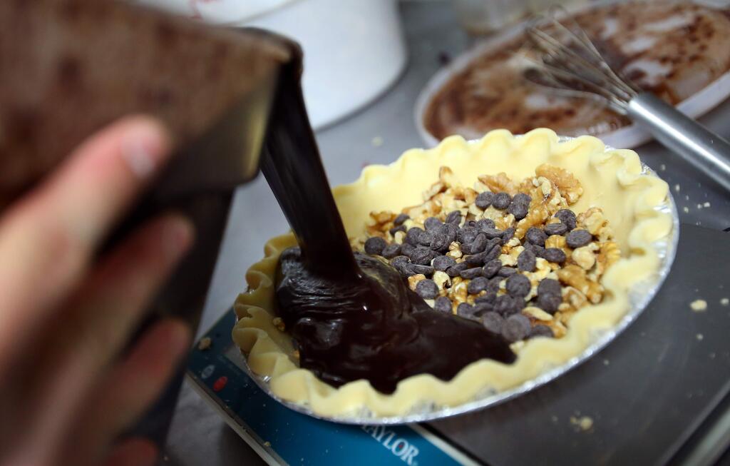 Head Baker Kyle Jones makes a chocolate walnut pie for Noble Folk Ice Cream and Pie Bar, in Healdsburg on Monday, September 22, 2014. (Christopher Chung/ The Press Democrat)