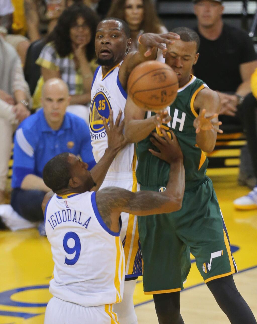 Golden State Warriors forward Kevin Durant and forward Andre Iguodala strip the ball from Utah Jazz guard Rodney Hood during Game 1 of the of NBA Western Conference Semifinals in Oakland on Tuesday, May 2, 2017. (Christopher Chung/ The Press Democrat)