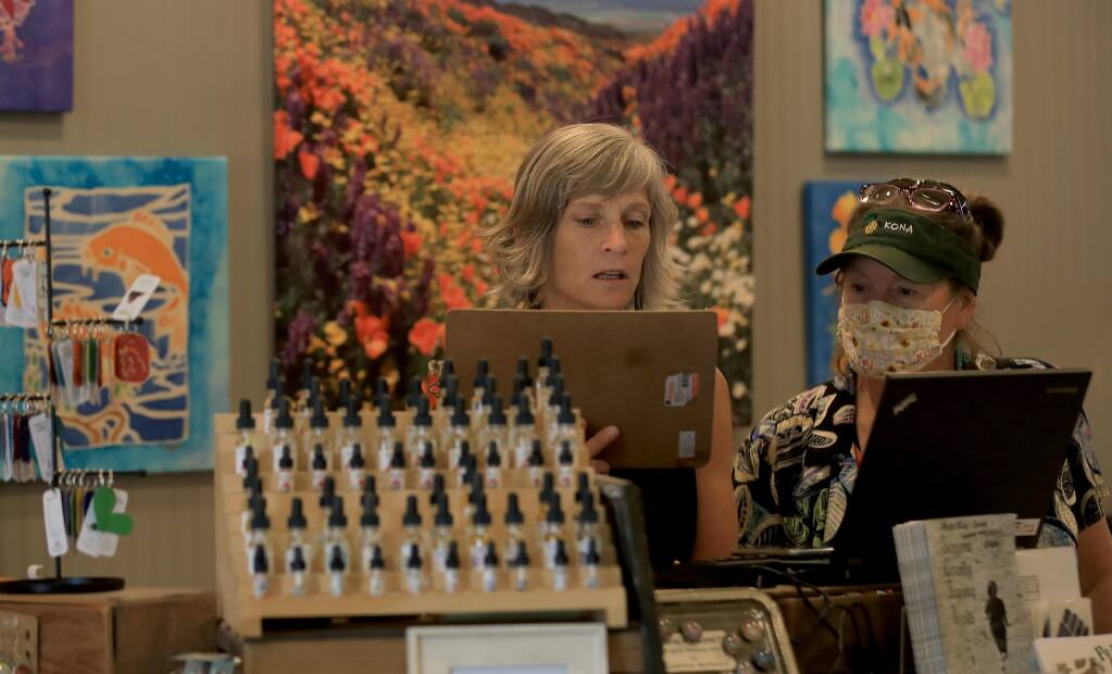 Made Local Marketplace co-owners Kelley Rajala, left, and Pam Dale discuss business items at the sales counter on Friday, June 19, 2020. (Kent Porter / The Press Democrat)
