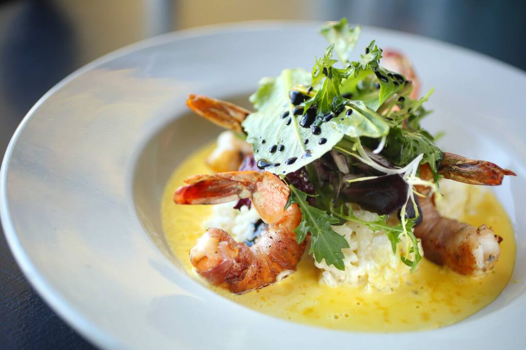 Pancetta wrapped grilled prawns on risotto with saffron cream sauce is served at Bruno's on Fourth in Santa Rosa on Wednesday, January 22, 2014. (Conner Jay/The Press Democrat)