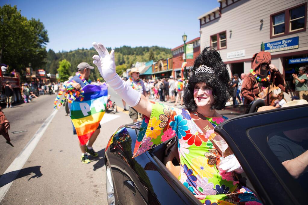'Miss Tipsy Timbers,' a.k.a. Jeff Falk of Guerneville, waves to the crowd at the 2014 Sonoma County Pride Parade from the passenger seat of a convertible Jaguar. (Charlie Gesell / For The Press Democrat)