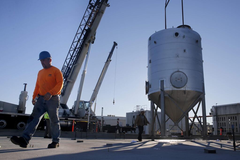 Jim McCall, a foreman from Pacific Infrastructure Corp. installs a high strength waste tank at the Laguna Treatment Plant in Santa Rosa, on Tuesday, December 15, 2015. (BETH SCHLANKER/ The Press Democrat)
