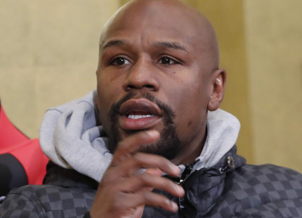 FILE - In this Dec. 29, 2018, file photo, Floyd Mayweather Jr. speaks during a news conference in Tokyo. Former boxing champion Mayweather has offered to pay for George Floyd's funeral and memorial services, and the family has accepted the offer. Mayweather personally has been in touch with the family, according to Leonard Ellerbe, the CEO of Mayweather Promotions. He will handle costs for the funeral on June 9 in Floyd's hometown of Houston, as well as other expenses. (AP Photo/Eugene Hoshiko, File)