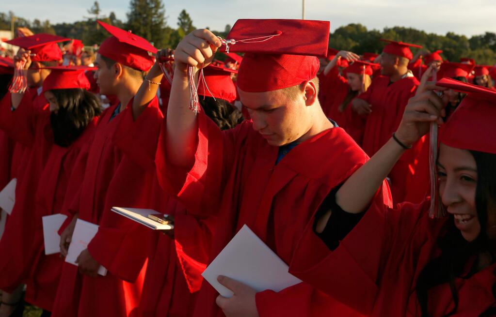 Montgomery High School seniors move their tassles to the right as they graduate last June in Santa Rosa. (ALVIN JORNADA / The Press Democrat)