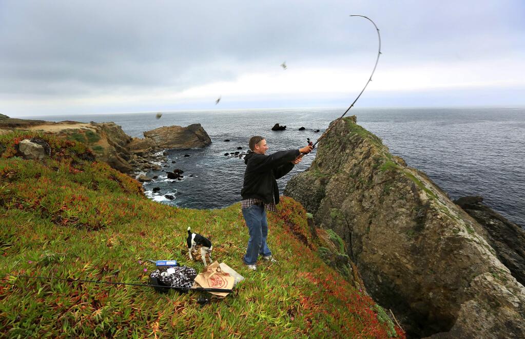 Ariel Schoenfeld of Timber Cove fishes from the bluff south of Stillwater Cove. Sonoma County Regional Parks is proposing a 3-mile trail connecting Stillwater Cove Regional Park and Ft. Ross State Historic Park. (Photo by John Burgess/The Press Democrat)