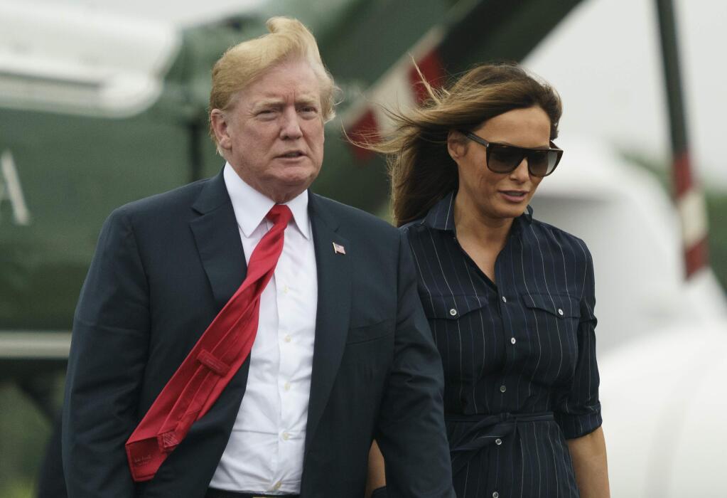 President Donald Trump and first lady Melania Trump walk from Marine One to board Air Force One at Morristown Municipal Airport, in Morristown, N.J., Sunday, July 22, 2018, en route to Washington after staying at Trump National Golf Club in Bedminster, N.J. (AP Photo/Carolyn Kaster)