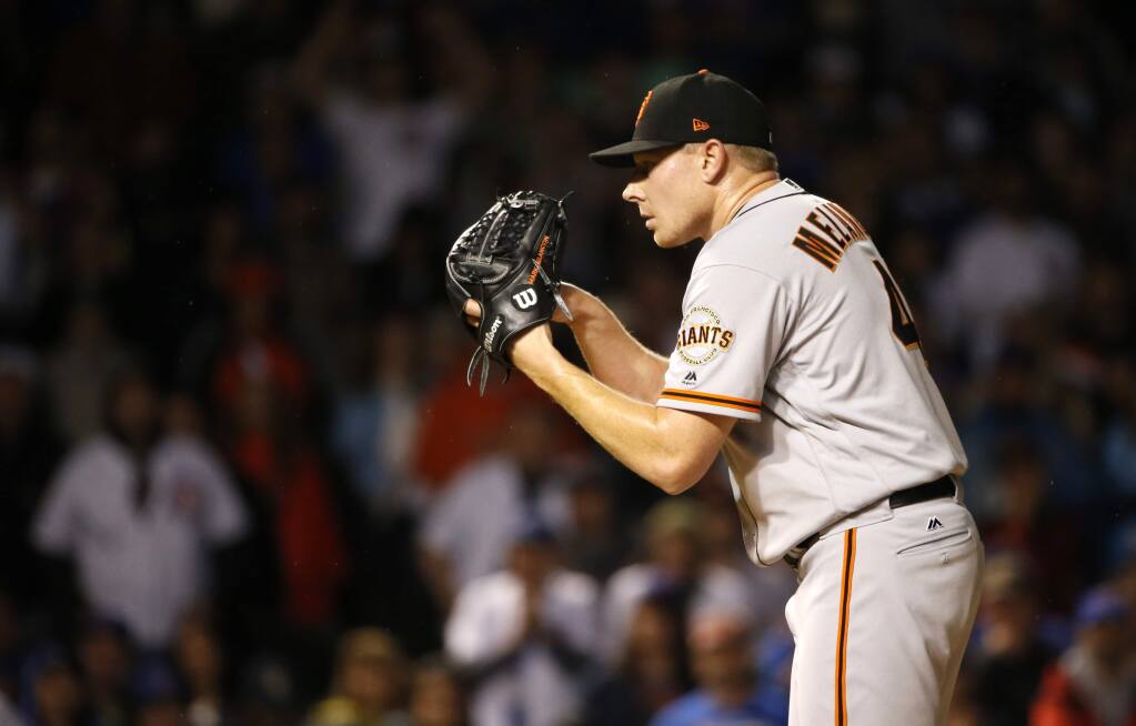 San Francisco Giants closer Mark Melancon gets a sign from catcher Buster Posey during the ninth inning against the Chicago Cubs, Monday, May 22, 2017, in Chicago. The Giants won 6-4. (AP Photo/Charles Rex Arbogast)