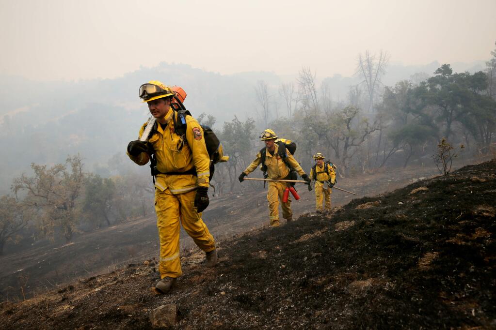 Cal Fire firefighters return from combating the Kincade fire along Coyote Ridge Road in Geyserville on Oct. 24, 2019. (BETH SCHLANKER/ PD)
