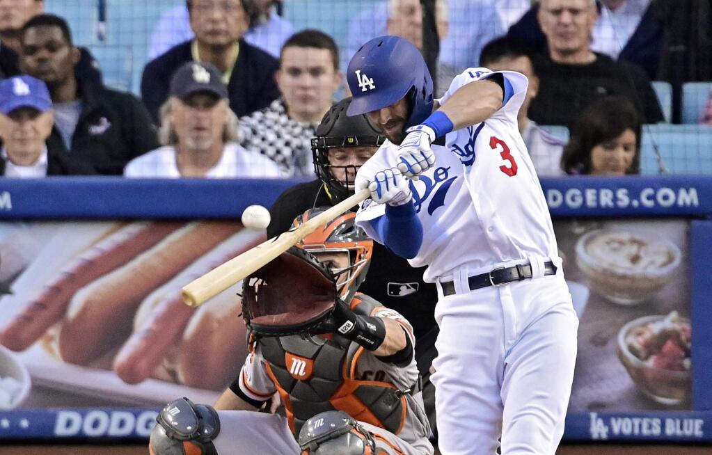 The Los Angeles Dodgers' Chris Taylor hits a three-run home run as San Francisco Giants catcher Buster Posey and home plate umpire Carlos Torres watch during the first inning Wednesday, June 19, 2019, in Los Angeles. (AP Photo/Mark J. Terrill)