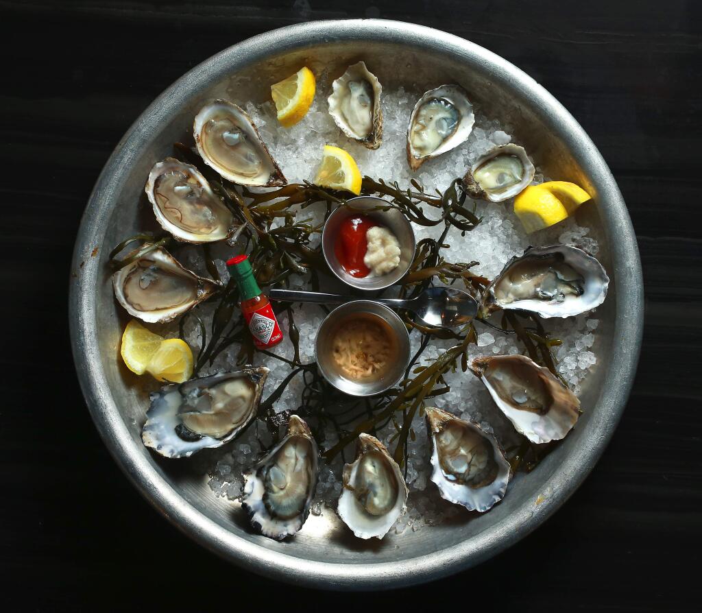 The Dozen Oyster plate include St. Simone, Kummomoto and Hog Island oysters from The Shuckery in Petaluma. (photo by John Burgess/The Press Democrat)