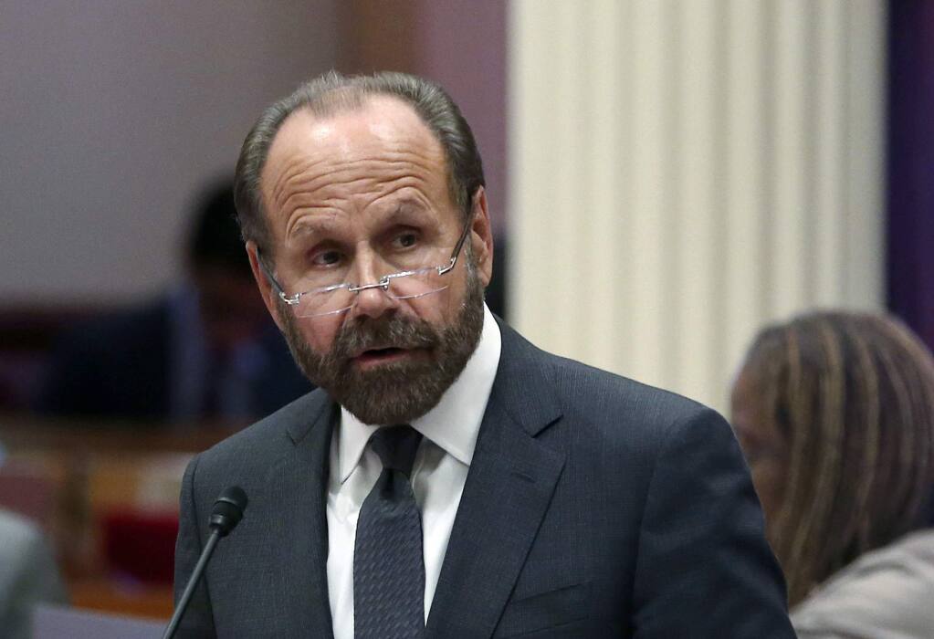 State Sen. Jerry Hill, D-San Mateo, speaks on the floor of the Senate, Monday, Aug. 27, 2018, in Sacramento, Calif. The state Assembly on Monday approved Hill's measure that allows parents to give their children medical marijuana on school campuses if school districts opt in. The bill was sent to Gov. Jerry Brown. (AP Photo/Rich Pedroncelli)