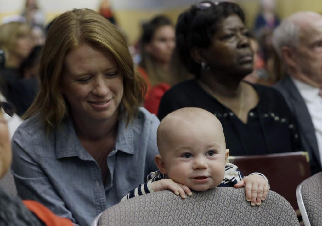 Jennifer Wonnacott, a supporter of a measure requiring California schoolchildren to get vaccinated, keeps an eye on her son, Gavin, at a hearing at the Capitol in Sacramento, Calif., Wednesday, April 8, 2015. Supporters and opponents of the SB277, by Sens. Richard Pan, D-Sacramento and Ben Allen, D-Santa Monica, spoke passionately during the hearing in the Senate Health Committee. (AP Photo/Rich Pedroncelli)