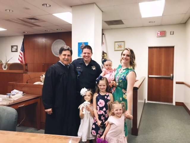 At back from left, Judge Ken Gnoss, SRPD officer Jesse Whitten and his wife, Ashley, who is holding their new adopted baby, Harlow. In front, from left, Kendall, 5, Reece, 7, and Stella, 3. (Jesse Whitten)