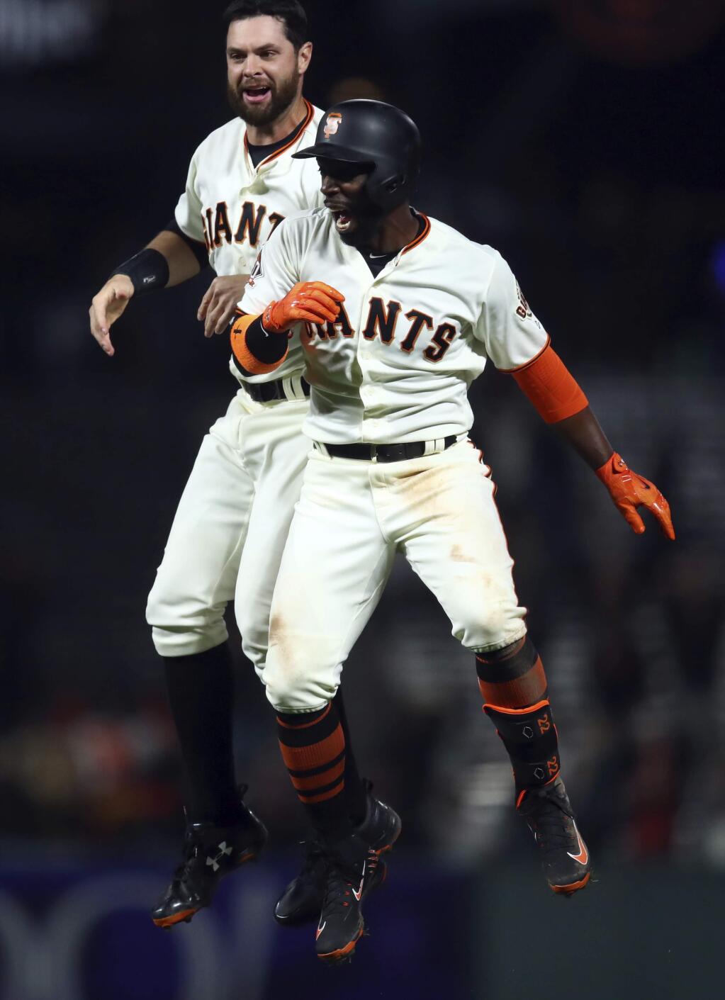 The San Francisco Giants' Andrew McCutchen, right, celebrates with Brandon Belt after his game-winning hit in the ninth inning against the Arizona Diamondbacks Tuesday, April 10, 2018, in San Francisco. (AP Photo/Ben Margot)
