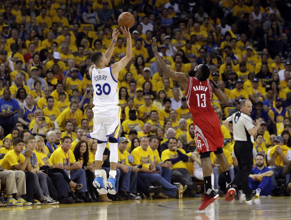 Golden State Warriors' Stephen Curry (30) makes a 3-point basket over Houston Rockets' James Harden (13) during the first half in Game 1 of a first-round NBA basketball playoff series Saturday, April 16, 2016, in Oakland, Calif. (AP Photo/Marcio Jose Sanchez)