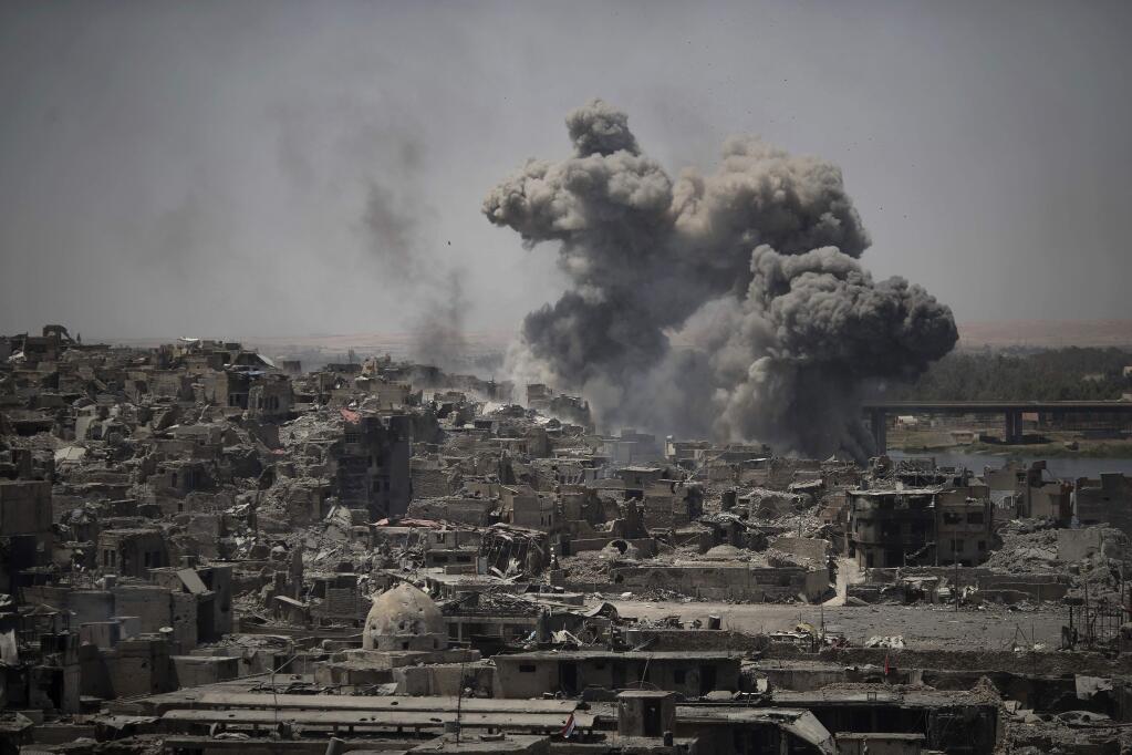 Airstrikes target Islamic State positions on the edge of the Old City a day after Iraq's prime minister declared 'total victory' in Mosul, Iraq, Tuesday, July 11, 2017. (AP Photo/Felipe Dana)