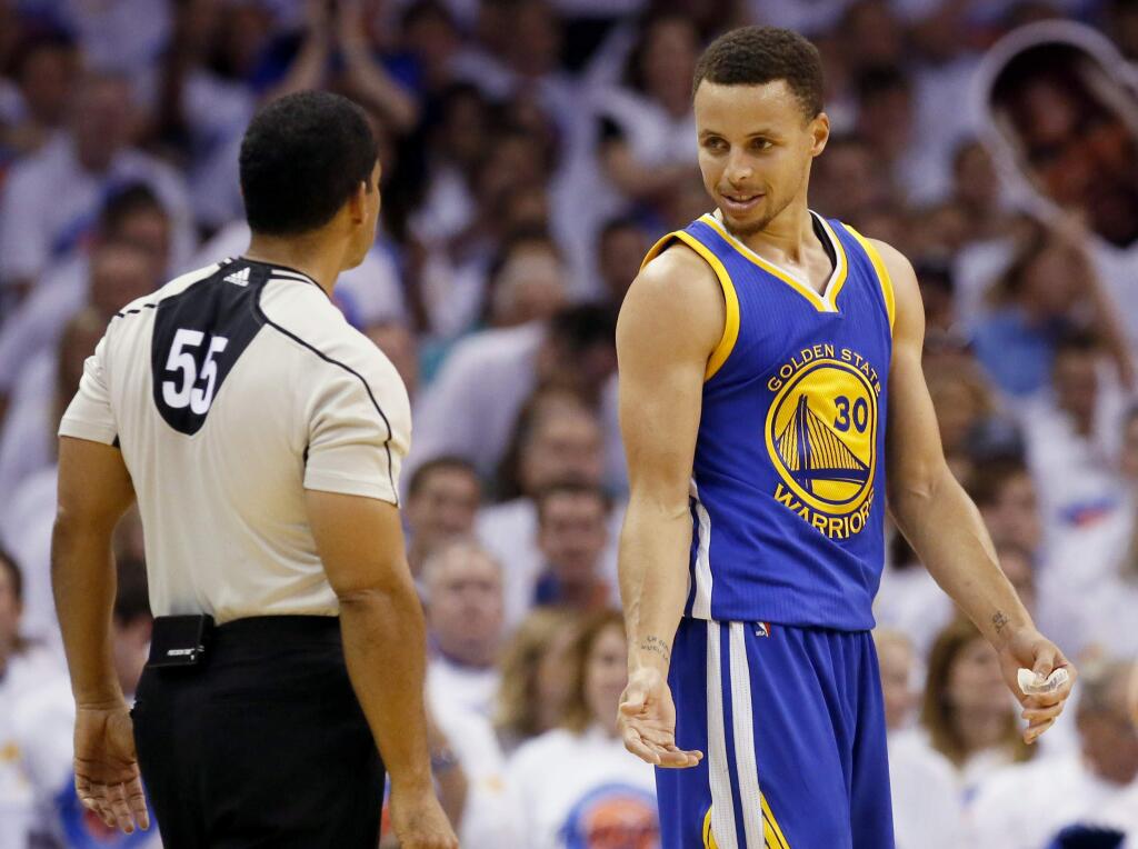 Golden State Warriors guard Stephen Curry (30) talks with referee Bill Kennedy (55) during the first half against the Oklahoma City Thunder in Game 4 of the NBA basketball Western Conference finals in Oklahoma City, Tuesday, May 24,, 2016. (AP Photo/Sue Ogrocki)