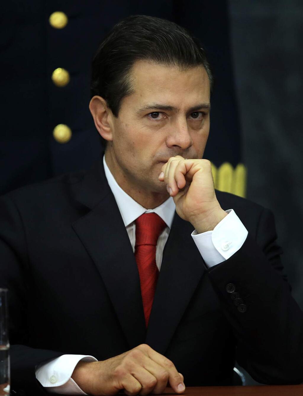 Mexico's President Enrique Pena Nieto pauses during a press conference at Los Pinos presidential residence in Mexico City, Monday, Jan. 23, 2017. Pena Nieto said Monday that Mexico's attitude towards the Donald Trump administration should not be aggressive or biased, but one of dialogue. (AP Photo/Marco Ugarte)