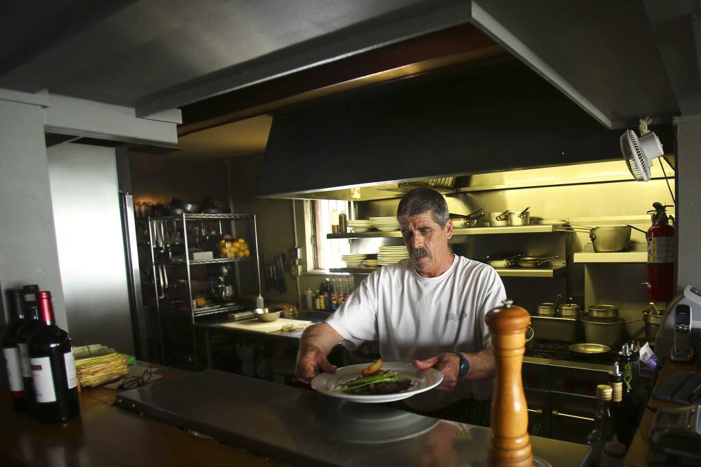 Corey Basso cooks at Le Bistro in 2014. The restaurant, which he owned, closed in 2017. Basso was arrested Wednesday, Aug. 26, 2020,  on suspicion of child molestation. (Conner Jay / The Press Democrat)