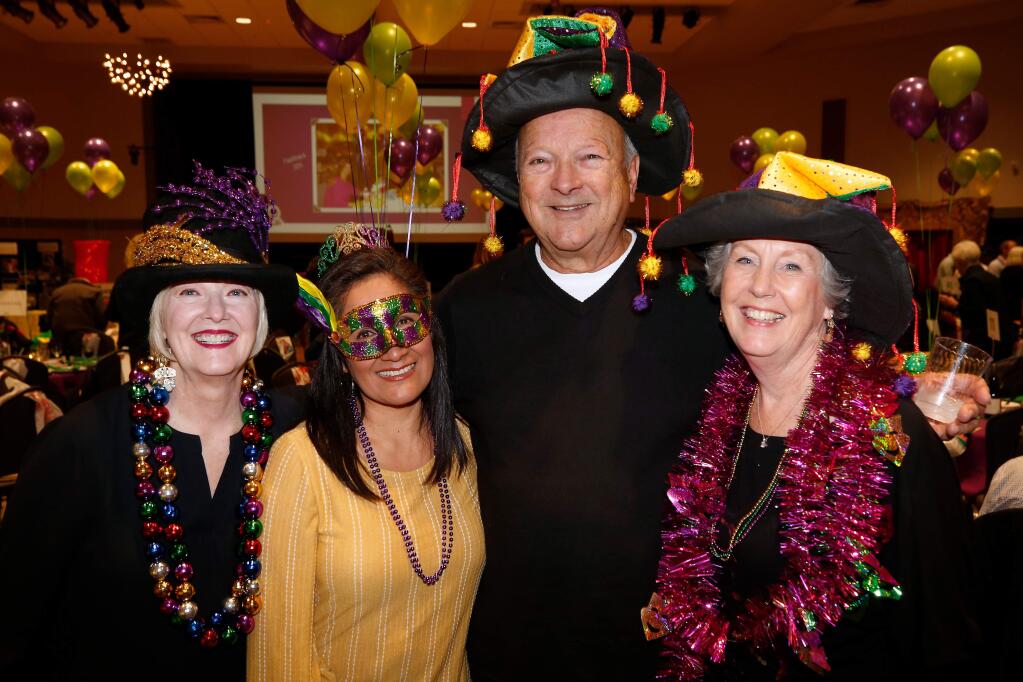 Cindy Denbo, left, Milagros Ott, Dean Nowacki, and Susan Nowacki attend a Mardi Gras party fundraiser by the Rotary Club of Santa Rosa West, which will primarily benefit the Child Parenting Institute, in Santa Rosa, California, on Saturday, February 16, 2019. (Alvin Jornada / The Press Democrat)