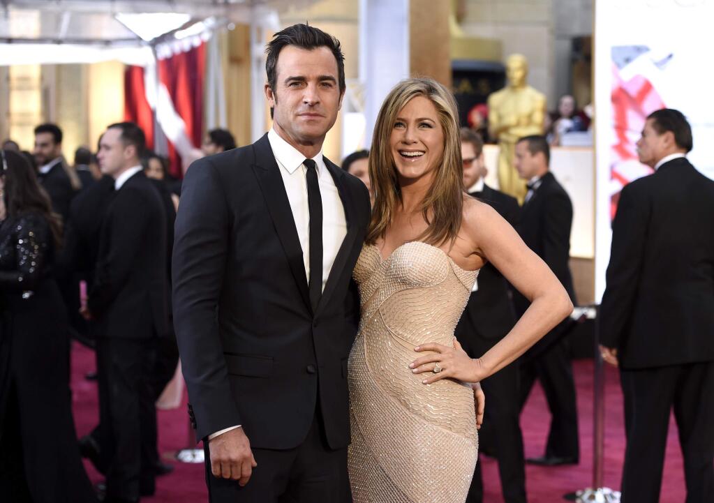 FILE - In this Feb. 22, 2015 file photo, Justin Theroux, left, and Jennifer Aniston arrive at the Oscars in Los Angeles. Howard Stern has revealed details about the secret wedding between Jennifer Aniston and Justin Theroux, including that Jimmy Kimmel officiated. Stern was a guest at the Los Angeles ceremony on Wednesday, Aug. 5, that Aniston and Theroux disguised as a birthday bash for Theroux. Stern said on his radio show Monday, Aug. 10, that he knew ahead of time it was a wedding because the couple asked him to give a speech. (Photo by Chris Pizzello/Invision/AP, File)