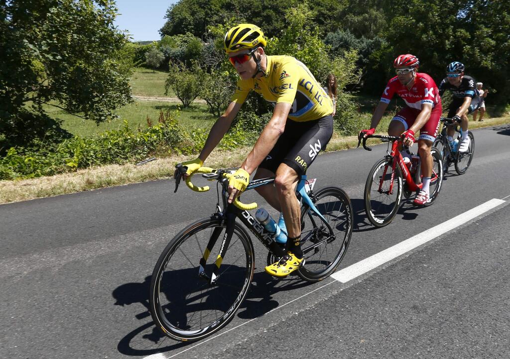 Britain's Chris Froome, wearing the overall leader's yellow jersey, rides during the fourteenth stage of the Tour de France cycling race over 208.5 kilometers (129.2 miles) with start in Montelimar and finish in Villars-les-Dombes, France, Saturday, July 16, 2016. (AP Photo/Peter Dejong)