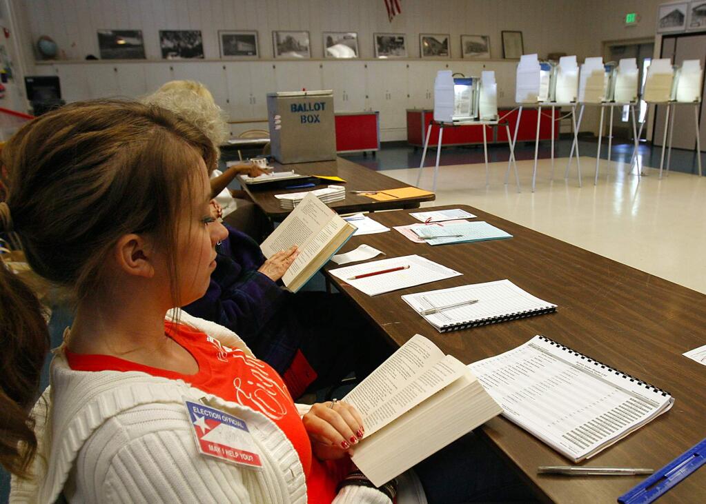 Polling Clerks Rheanna Spencer, front, and Cassandra Lista caught up on their reading while waiting for voters in the special election on Tuesday at Helen Lehman Elementary School. (John Burgess/The Press Democrat)