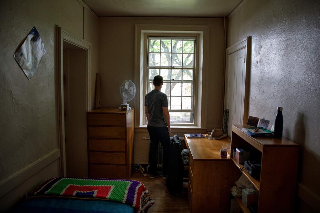 In this Tuesday, May 23, 2017, photo, provided by Facebook, CEO Mark Zuckerberg looks out the window in his old dorm room at Harvard University, in Cambridge, Mass. Zuckerberg started Facebook in his dorm room in 2004, and also met his wife, Priscilla Chan, at Harvard. On Thursday, May 25, Zuckerberg will give the commencement address at the university, where he dropped out years earlier to focus on Facebook. (Courtesy of Ommanney/Facebook via AP)