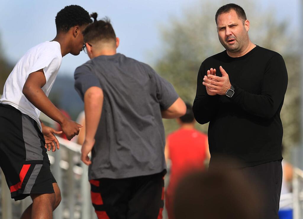 Montgomery High School head football coach Tony Keefer, cheers on his players as they run Montgomery's stadium stairs during spring conditioning, Thursday March 16, 2017 in Santa Rosa. (Kent Porter / The Press Democrat)