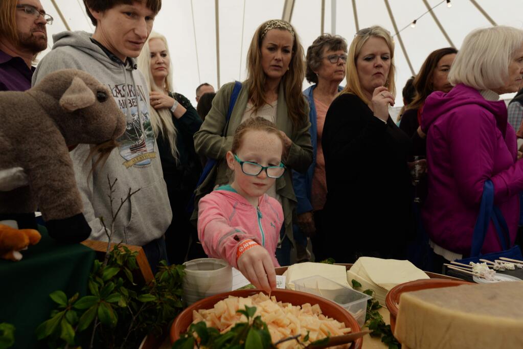 Evelyn Wood, 8, in pink, sampling Boont Corners Reserve, a 10-month aged goat/sheep milk cheese at the Penny Royal Farm booth with her father Scott Wood, left, from Santa Rosa, during the 11th annual California Artisan Cheese Festival held at the Sheraton Sonoma County in Petaluma Sunday. March 26, 2017.(Photo: Erik Castro/for The Press Democrat)