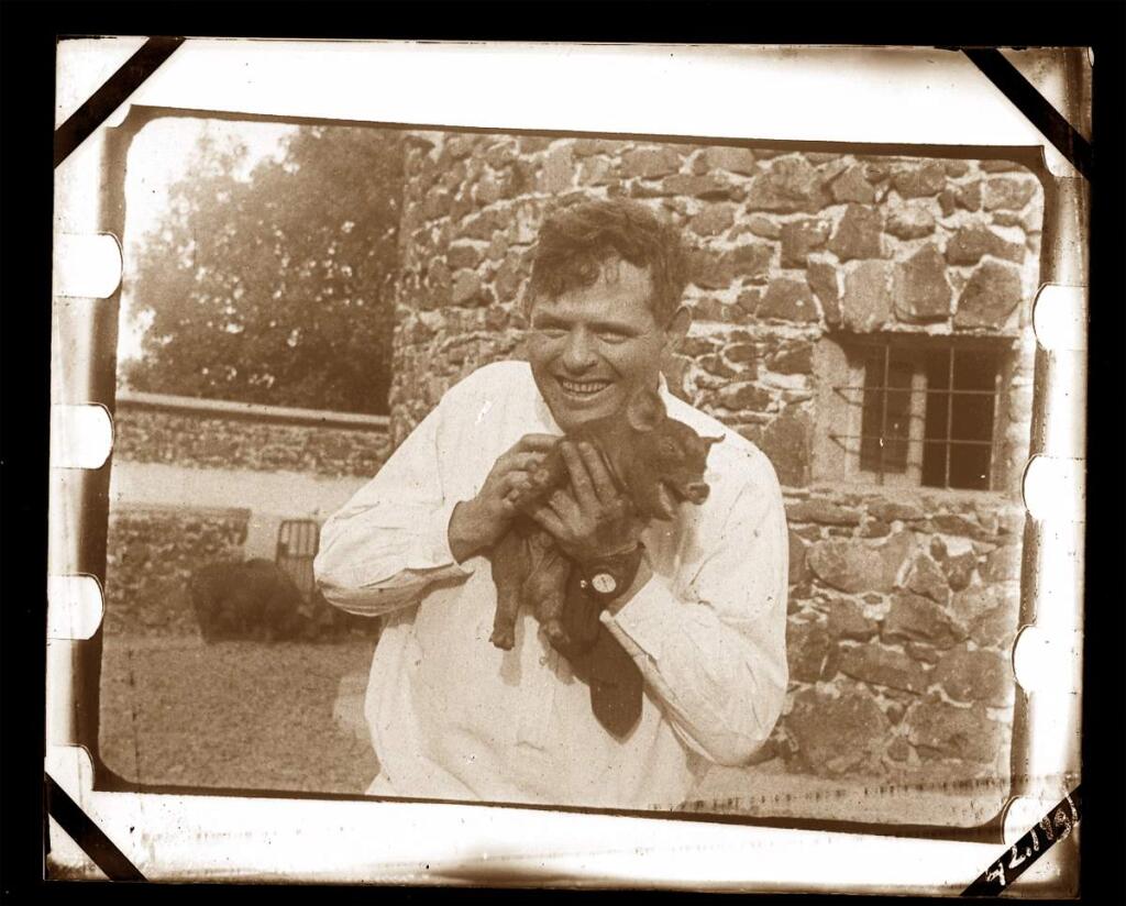 Jack London holds a piglet at the revolutionary Pig Palace on his Beauty Ranch. (California State Parks, 2016)