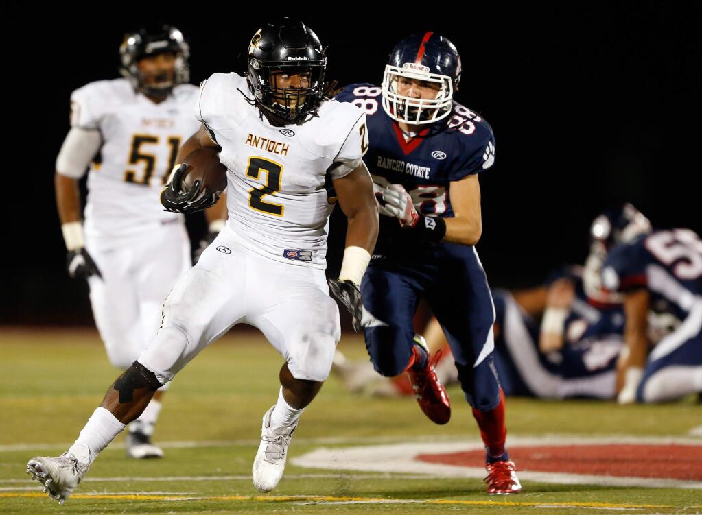 Antioch's Najee Harris (2) carries the ball while pursued by Rancho Cotate's Connor Barbato (88) during the first half of a varsity football game between Antioch and Rancho Cotate high schools, in Rohnert Park, California on Friday, September 16, 2016. (Alvin Jornada / The Press Democrat)