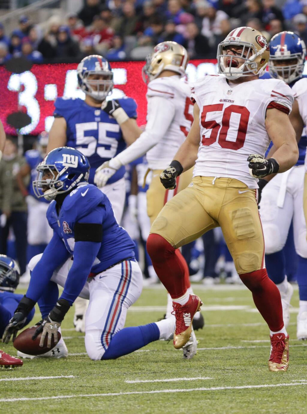 San Francisco 49ers inside linebacker Chris Borland (50) celebrates after tackling New York Giants running back Andre Williams (44) in the backfield during the second half of a game Sunday, Nov. 16, 2014, in East Rutherford, N.J. (AP Photo/Julio Cortez)