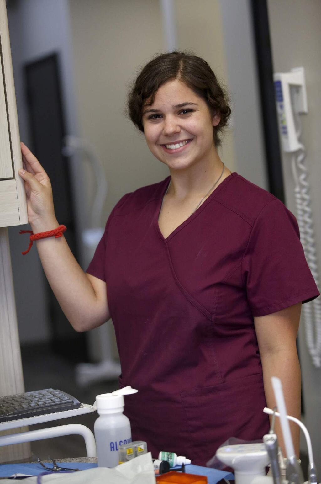 Technology High senior Brooke Wilson volunteers in a dental office in Petaluma on Tuesday, Aug.5, 2014. (BETH SCHLANKER / The Press Democrat)