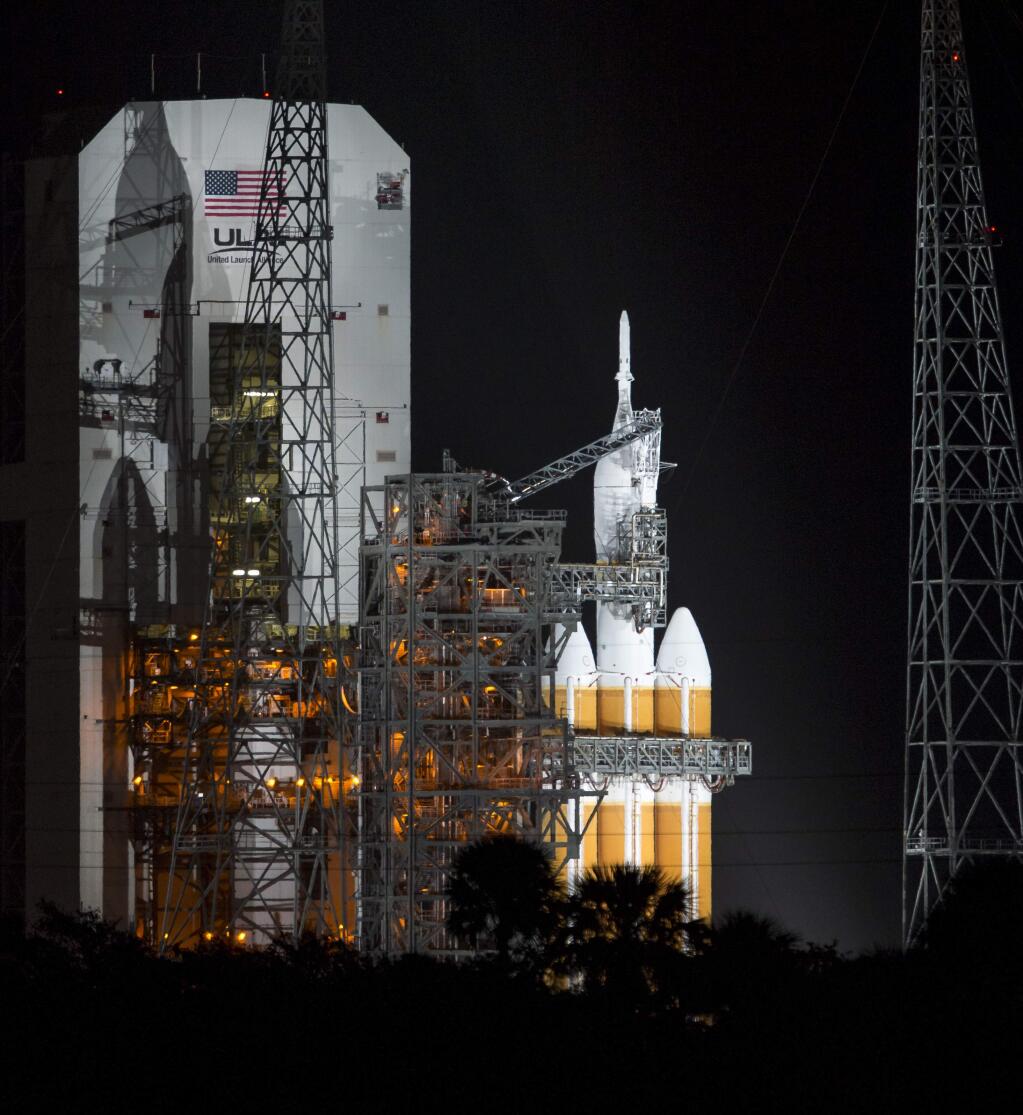 In this photo provided by NASA shows NASA's Orion spacecraft, atop a United Launch Alliance Delta 4-Heavy rocket, sits on the launch pad before its first unmanned orbital test flight from the Cape Canaveral Air Force Station Friday, Dec. 5, 2014, in Cape Canaveral, Fla. (AP Photo/NASA, Bill Ingalls)