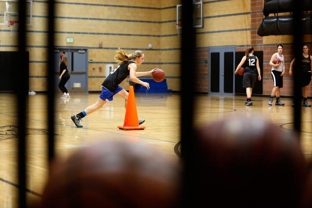 Windsor's Maddie Call dribbles around a cone during a layup drill during girls varsity basketball practice in Windsor, California on Thursday, December 3, 2015. (Alvin Jornada / The Press Democrat)